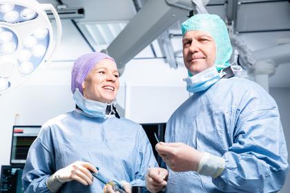 A physician and a nurse in an operating room.