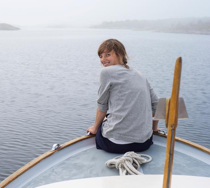 A girl sits in a boat.