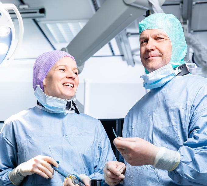 A physician and a nurse in an operating room.